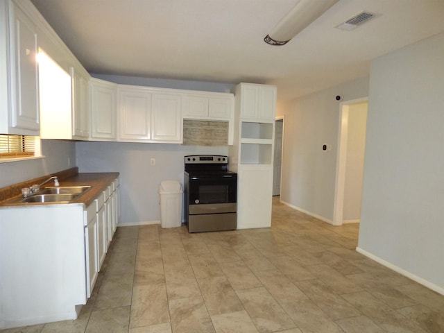 kitchen with white cabinets, stainless steel electric range oven, and sink