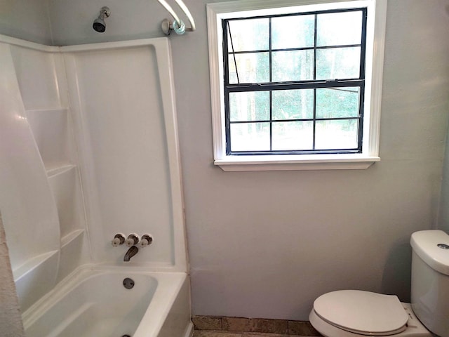 bathroom featuring toilet and washtub / shower combination