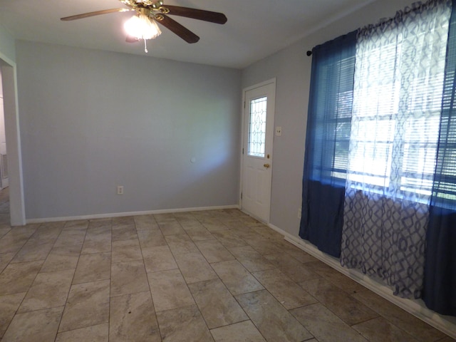 empty room featuring ceiling fan and light tile patterned floors