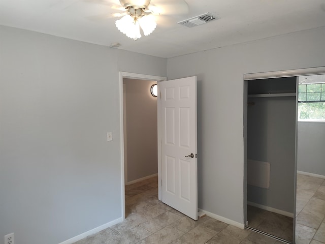 unfurnished bedroom featuring a closet and ceiling fan