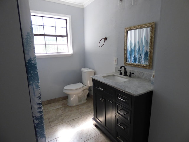 bathroom with tile patterned floors, vanity, toilet, and ornamental molding