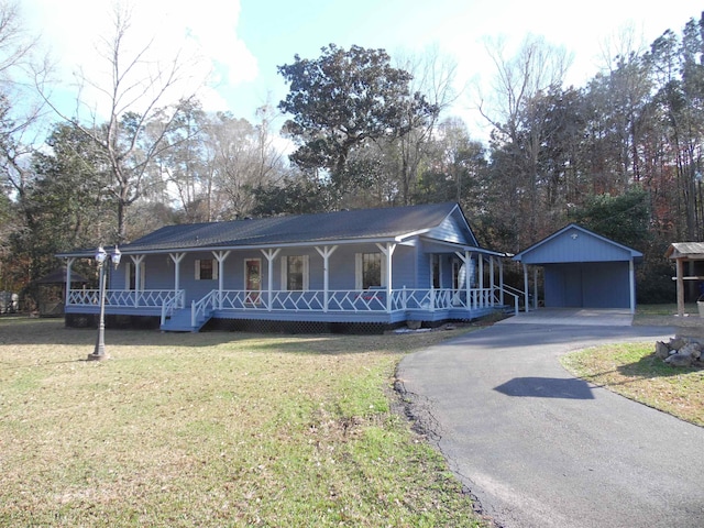 view of front of house featuring a carport, a front yard, and covered porch