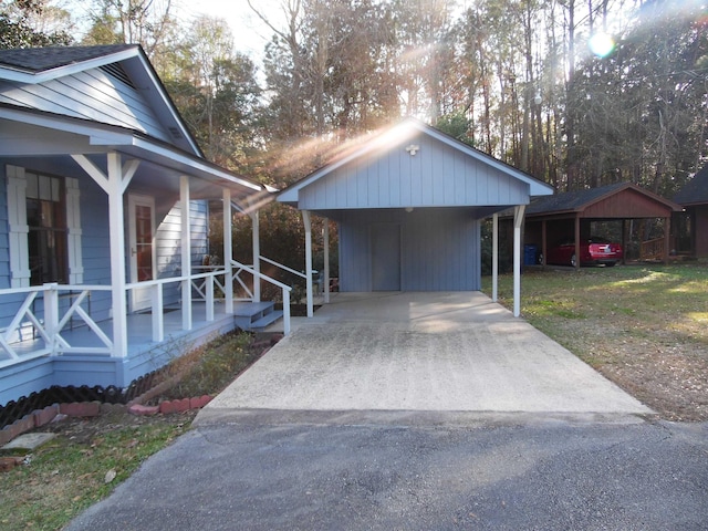 view of side of property with a yard and covered porch