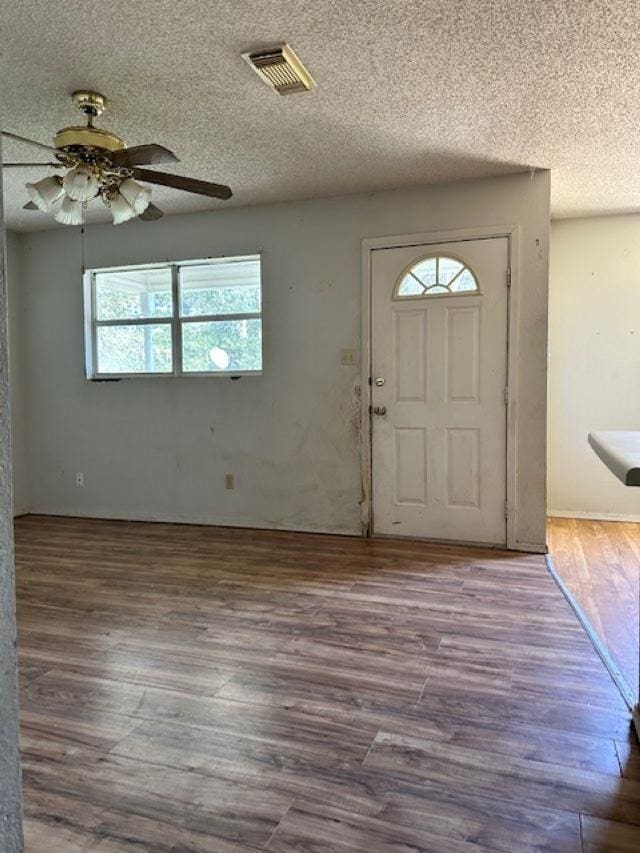 entrance foyer with ceiling fan, hardwood / wood-style floors, and a textured ceiling