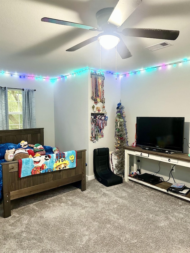 carpeted bedroom with ceiling fan and visible vents