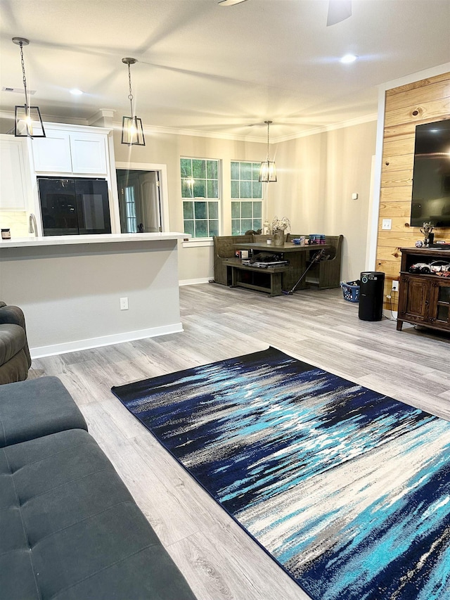 living room with baseboards, visible vents, and light wood finished floors