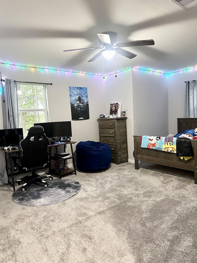 bedroom with carpet flooring, visible vents, and ceiling fan