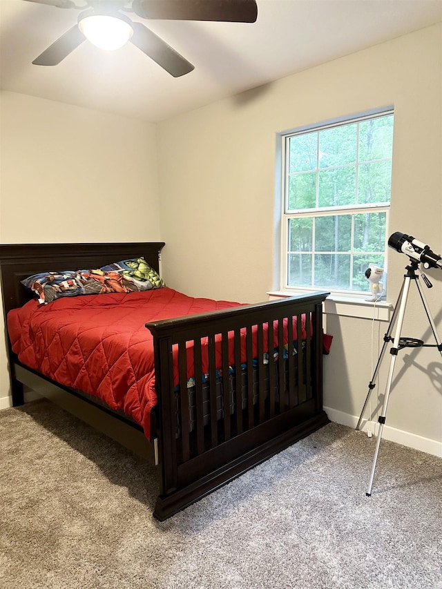 carpeted bedroom with baseboards and ceiling fan
