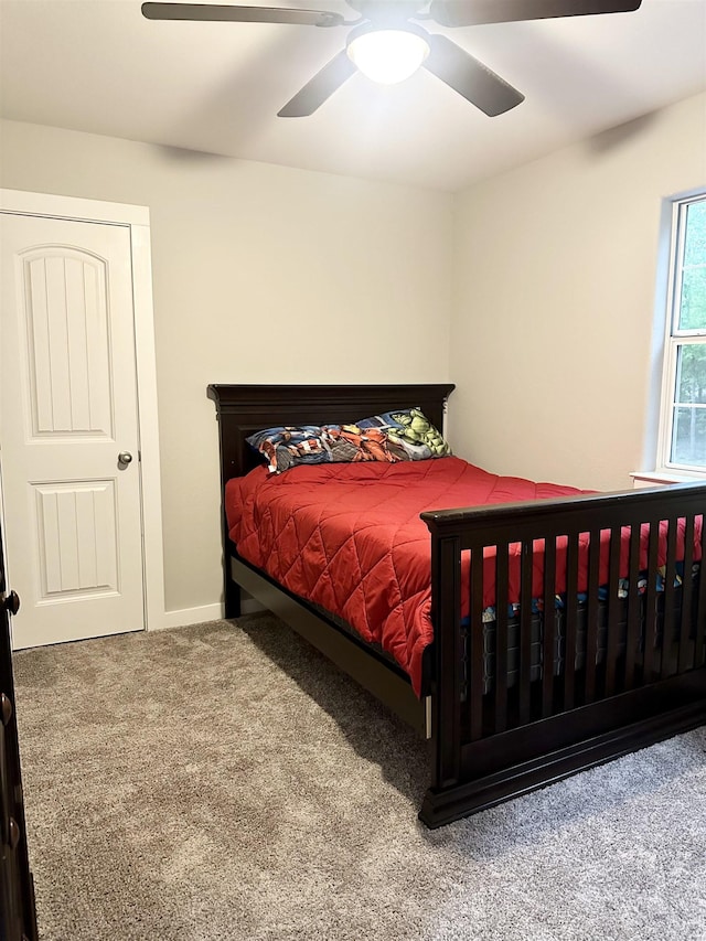 bedroom with ceiling fan and carpet