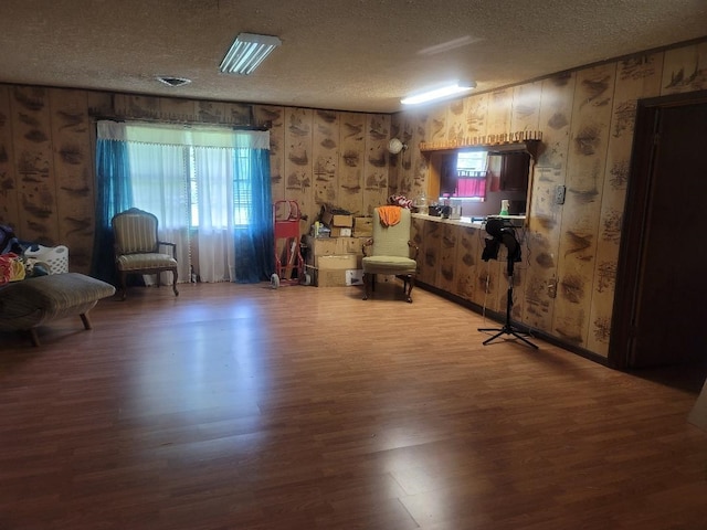 unfurnished room featuring a textured ceiling and hardwood / wood-style flooring