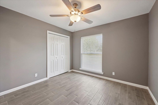 2024 International Ave, Orange, TX 77632 - unfurnished bedroom with wood finished floors, a closet, and ceiling fan