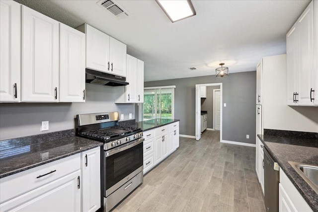 2024 International Ave, Orange, TX 77632 - kitchen featuring stainless steel range with gas cooktop, under cabinet range hood, dishwashing machine, white cabinetry, and light wood finished floors