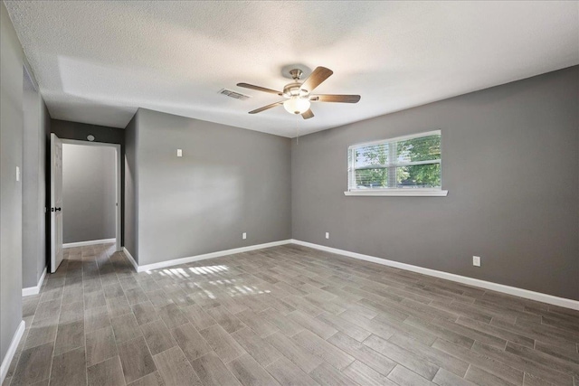 2024 International Ave, Orange, TX 77632 - empty room with ceiling fan, wood finished floors, and a textured ceiling