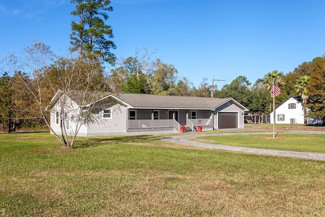 ranch-style house with a garage, a front yard, covered porch, and driveway