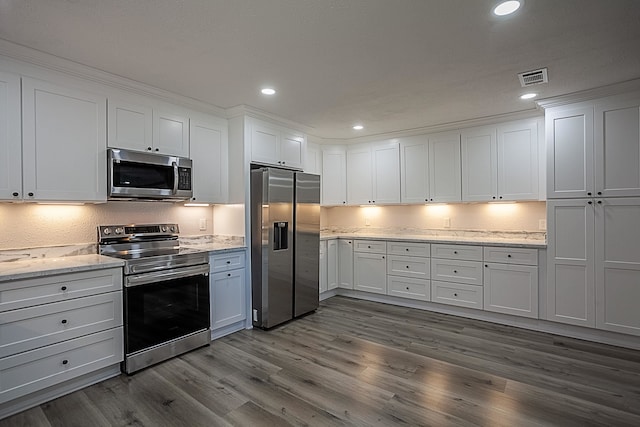 kitchen featuring visible vents, appliances with stainless steel finishes, white cabinets, and dark wood-type flooring