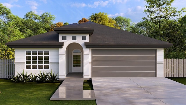 view of front of house with a front yard and a garage