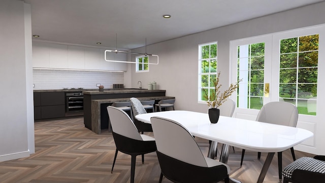 dining area with sink, dark parquet floors, and beverage cooler