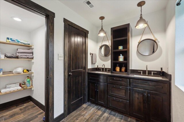 1185 Pinecrest St, Vidor, TX 77662 - bathroom featuring wood finished floors and double vanity