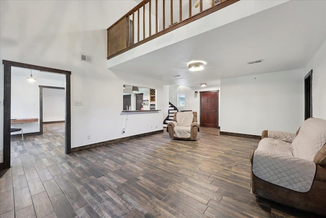 1185 Pinecrest St, Vidor, TX 77662 - sitting room with dark wood-style floors, stairway, baseboards, and a high ceiling