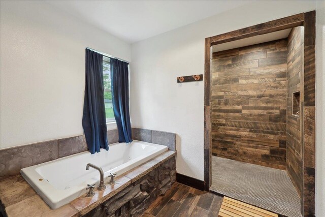 1185 Pinecrest St, Vidor, TX 77662 - full bath featuring a tub with jets, walk in shower, and wood finished floors