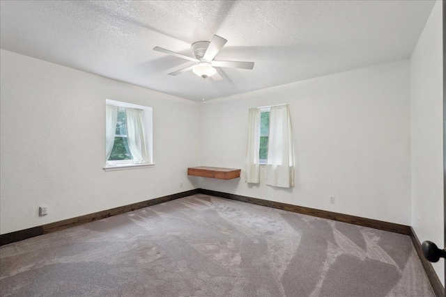 1185 Pinecrest St, Vidor, TX 77662 - unfurnished room with plenty of natural light, carpet, baseboards, and a textured ceiling