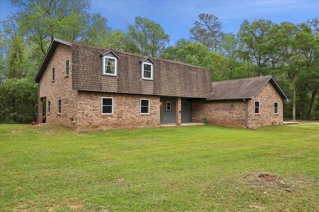 1185 Pinecrest St, Vidor, TX 77662 - view of front of property with brick siding, a shingled roof, a front lawn, and a patio area