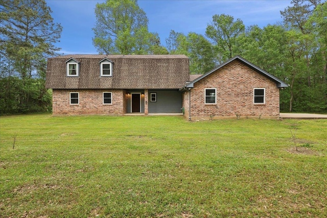 1185 Pinecrest St, Vidor, TX 77662 - back of house with a shingled roof, brick siding, and a lawn