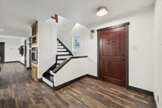 1185 Pinecrest St, Vidor, TX 77662 - entryway with dark wood finished floors, stairs, and baseboards