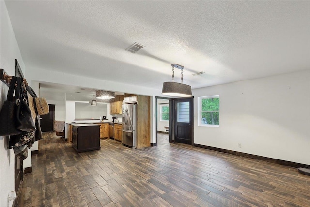 1185 Pinecrest St, Vidor, TX 77662 - kitchen featuring stainless steel appliances, dark wood finished floors, open floor plan, and a textured ceiling