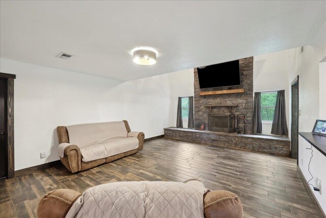 1185 Pinecrest St, Vidor, TX 77662 - living room with a stone fireplace, wood finished floors, and baseboards