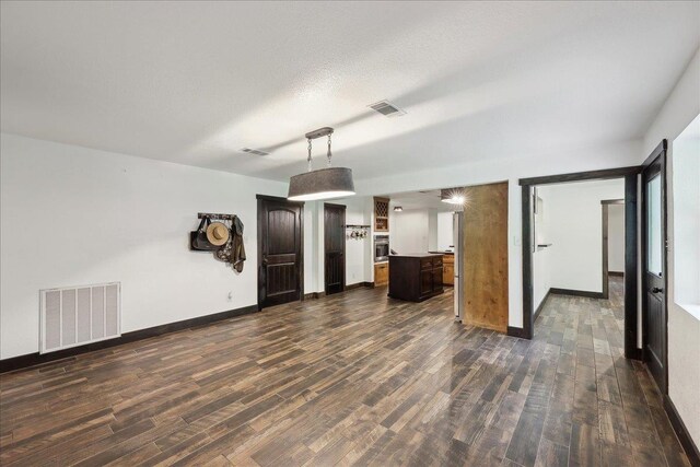 1185 Pinecrest St, Vidor, TX 77662 - unfurnished living room featuring dark wood-style floors and baseboards