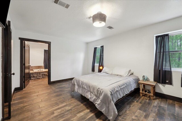 1185 Pinecrest St, Vidor, TX 77662 - bedroom with multiple windows, wood finished floors, baseboards, and a textured ceiling