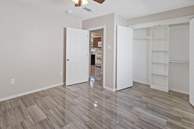 unfurnished bedroom featuring ceiling fan, a closet, and light hardwood / wood-style floors