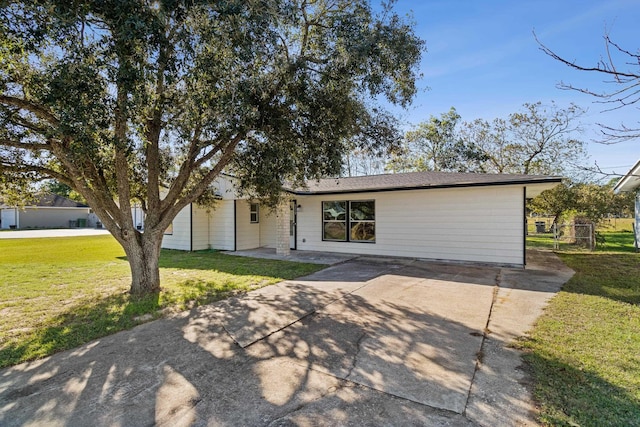 6259 Pat Ave, Port Arthur, TX 77640 - view of front facade with a front yard, concrete driveway, and a patio area