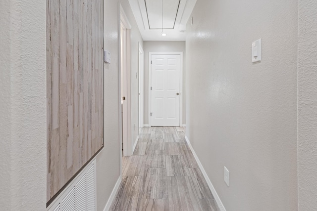 6259 Pat Ave, Port Arthur, TX 77640 - hallway featuring attic access, wood finished floors, and a textured wall