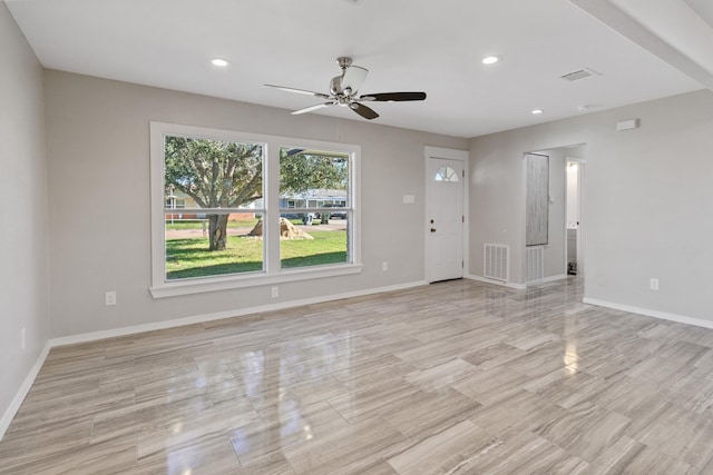 unfurnished living room with ceiling fan