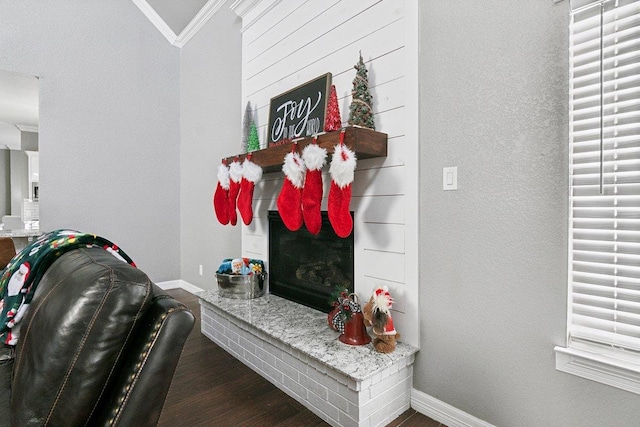 mudroom featuring lofted ceiling, crown molding, a fireplace, and dark hardwood / wood-style floors