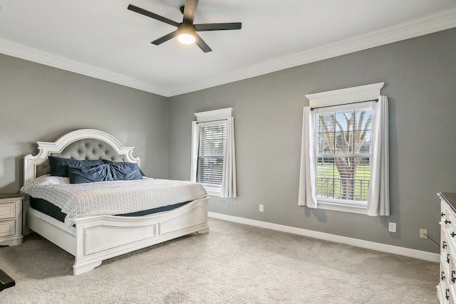 carpeted bedroom featuring ceiling fan and ornamental molding