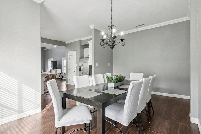 dining area with ornamental molding, dark hardwood / wood-style flooring, and a notable chandelier