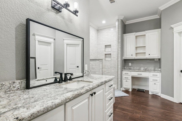 bathroom with hardwood / wood-style flooring, vanity, and crown molding