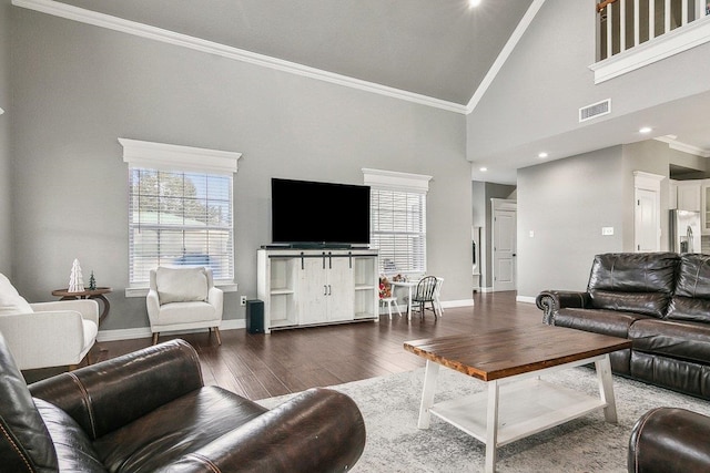 living room with hardwood / wood-style floors, ornamental molding, and high vaulted ceiling