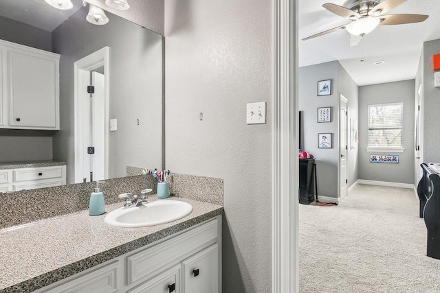 bathroom with ceiling fan and vanity