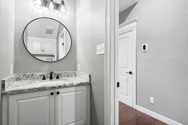 bathroom with vanity and wood-type flooring