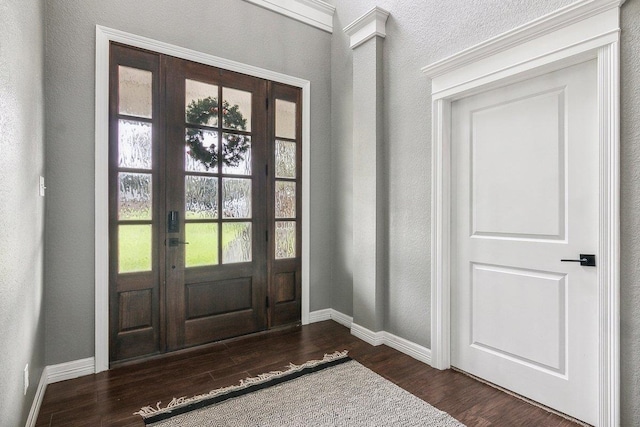 entryway featuring dark hardwood / wood-style floors and ornamental molding