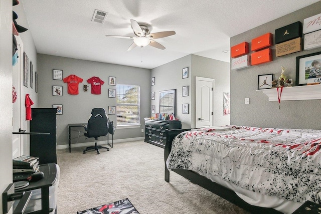 bedroom featuring carpet, ceiling fan, and a textured ceiling