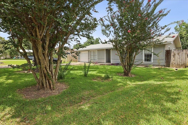 5150 Stardust Dr, Beaumont, TX 77706 - view of yard featuring an attached garage