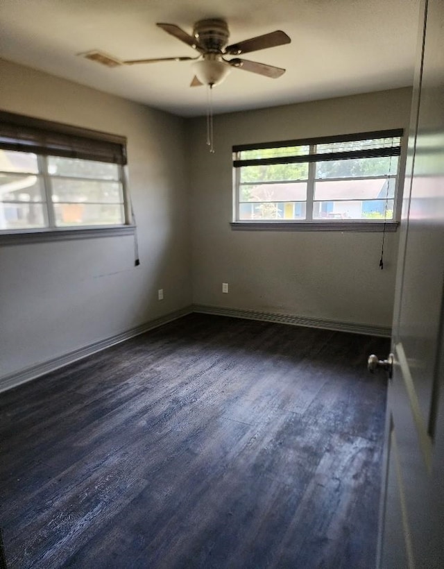 unfurnished room featuring ceiling fan and dark hardwood / wood-style flooring