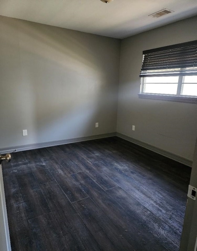 unfurnished room featuring dark hardwood / wood-style flooring