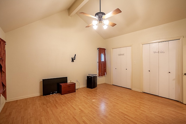 unfurnished bedroom with high vaulted ceiling, ceiling fan, beam ceiling, light hardwood / wood-style floors, and multiple closets