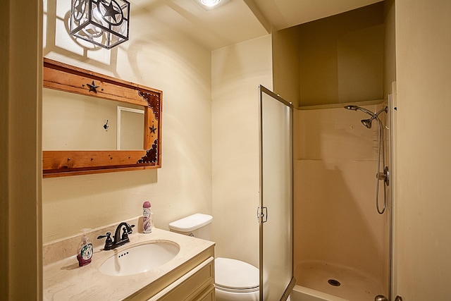 bathroom with toilet, a shower, and vanity